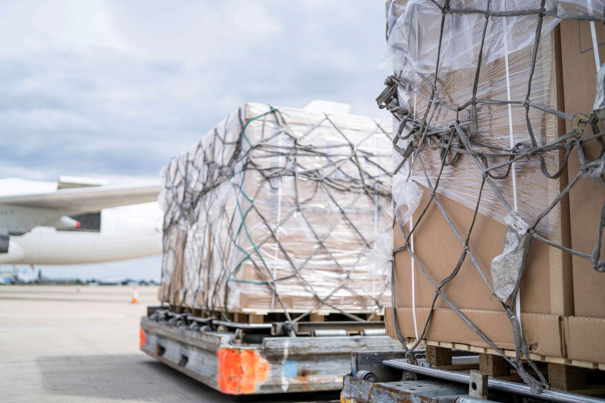 freight on trucks being transported to aircrafts